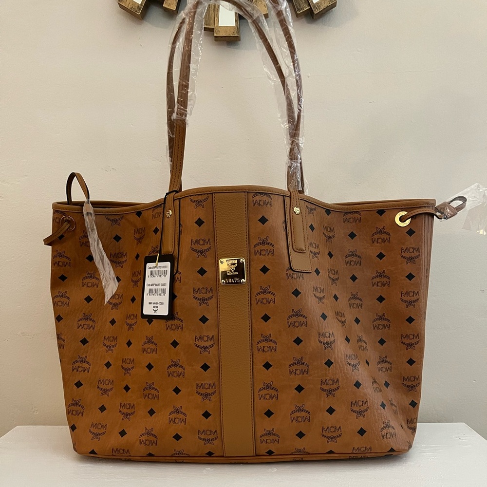 A striking Italian-crafted shopper reverses from a heritage logo print MCM bag!